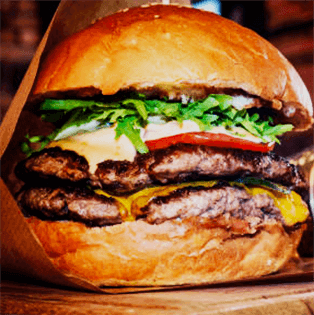 Juicy burger with lettuce, tomato, and melted cheese