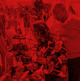 Couple shopping at a decorated indoor market with local goods