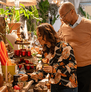 Couple shopping at a decorated indoor market with local goods