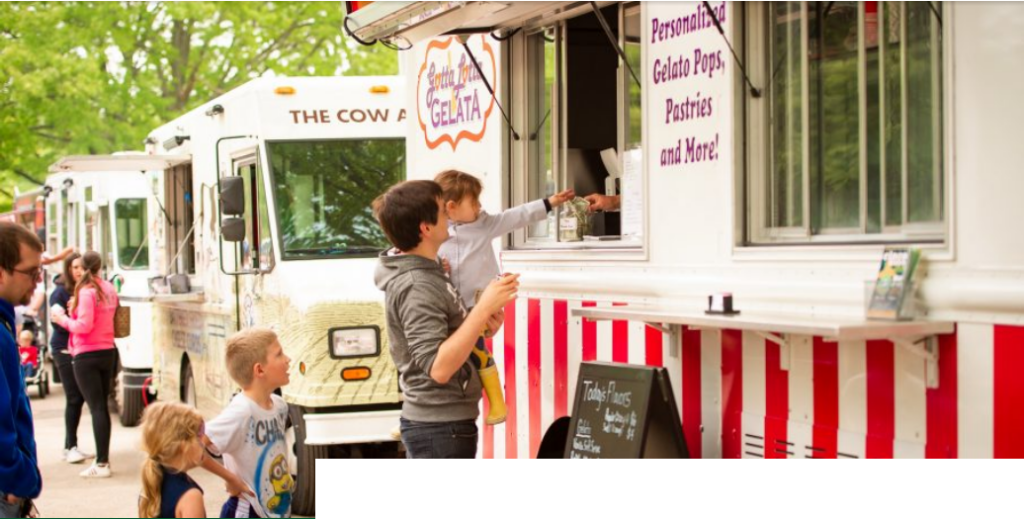 Families ordering at food trucks.